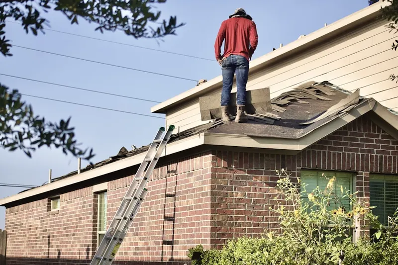 Professional roofer working on a residential roof in Pasadena on The Gulf